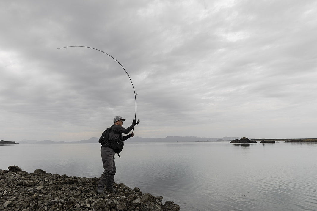 Angler loading the Shimano 26 Lunamis during a shore cast in Shimano's Japanese promotional photography