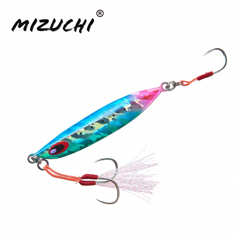 A Mizuchi fishing lure with a metallic blue and green body, pink head, orange-red hooks, and a white skirt, shown on a plain white background with the Mizuchi brand name in the top left.