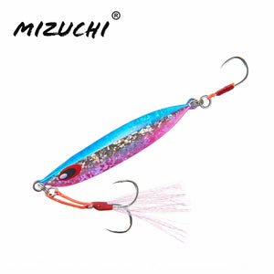 A Mizuchi fishing lure with a metallic blue and pink body, silver glitter, red accents, and a white feather skirt, shown on a plain white background with the Mizuchi brand name in the top left.