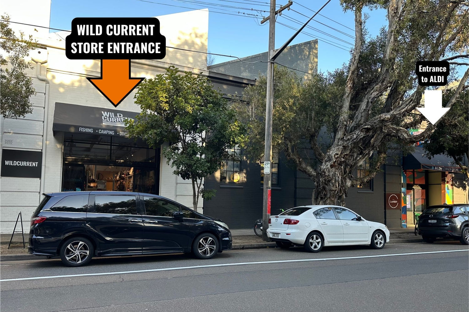 Street view of a storefront with overlaid arrows and text reading 'WILD CURRENT STORE ENTRANCE' on Dunning Avenue, Rosebery, which is beside the 'Entrance to ALDI'. 